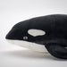 The IKEA Soft Toy Orca/Black White displayed on a shelf with other marine-themed items, showcasing its versatility and charm.
