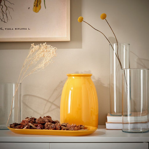 The IKEA KOPPARBJÖRK Decoration Dish displayed on a shelf, its vibrant yellow hue catching the eye and adding flair to the decor.