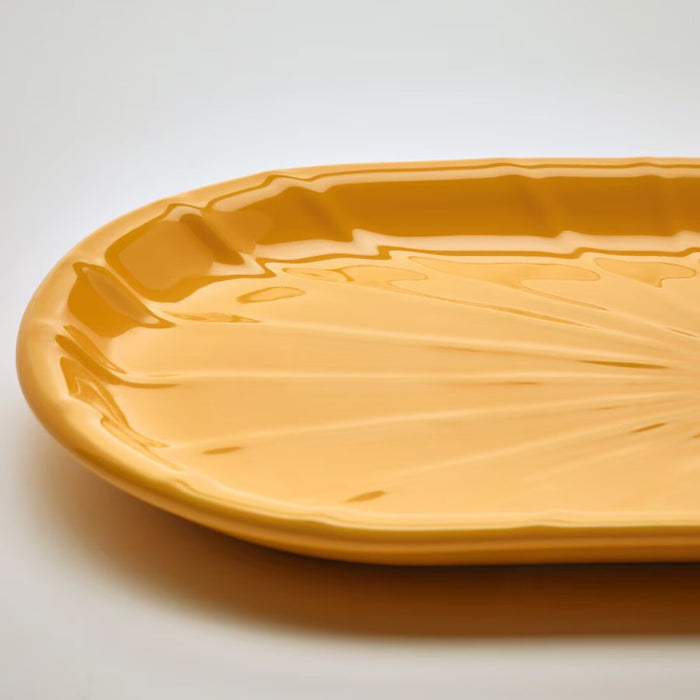 The IKEA KOPPARBJÖRK Decoration Dish placed on a coffee table, its bright yellow color creating a cheerful atmosphere in the room.