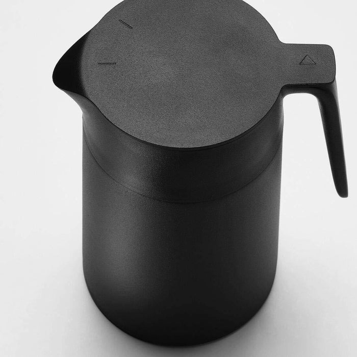 A close-up of the vacuum flask's black lid and handle, showing its smooth and ergonomic design. 50360231