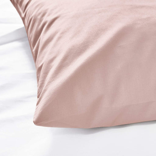 The edge of a pink pillowcase from IKEA, highlighting its bright and cheerful color