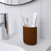A ceramic toothbrush holder with a colorful and ornate pattern, adding a decorative touch to a bathroom sink.-20542308