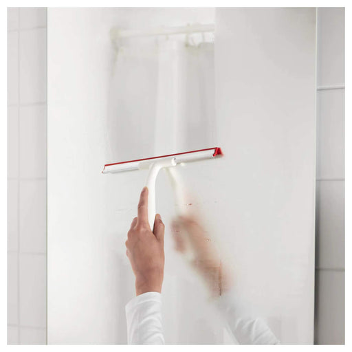 An image of IKEA's squeegee in use, showing its flexible rubber blade and comfortable grip for efficient cleaning. 20243597
