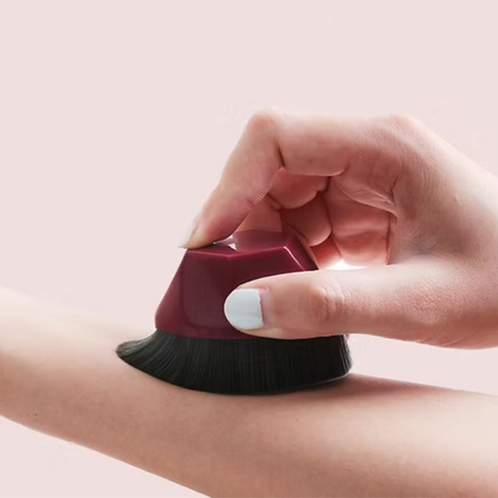 Digital Shoppy Hand pressing petal makeup brush against forearm to demonstrate ergonomic grip