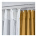 White and mustard yellow striped curtains on a rod with white hooks.
