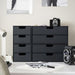 Black storage drawers on a desk with office supplies in a minimalistic office setting