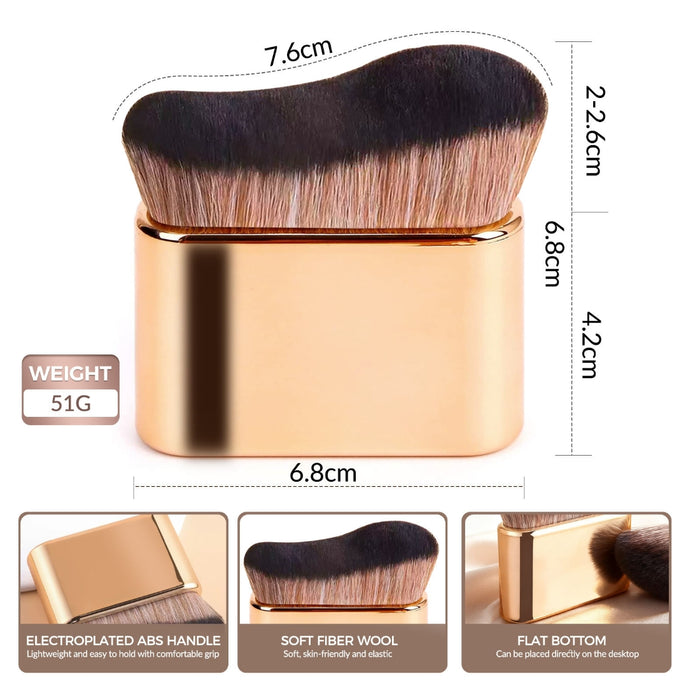 gold curved makeup brush with soft fiber wool bristles standing upright on flat bottom surface