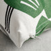 Close-up of a green and white fabric with a zipper on a gray surface