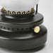 Close-up of a black lantern with gold accents on a light gray background