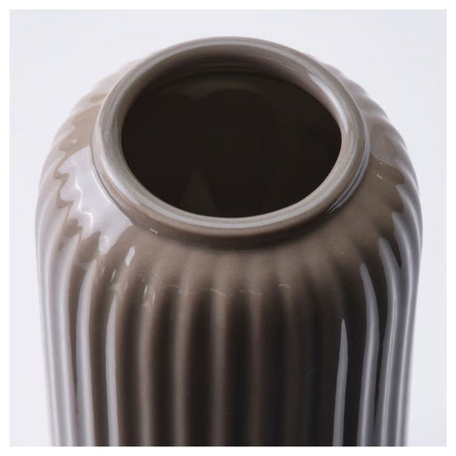 Close-up of a ribbed brown ceramic vase on a white background