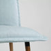 Close-up of KLINTEN chair, brown with Kilanda pale blue fabric, showing its elegant design and soft seating 20547042