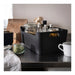 Black storage bin with kitchen items on a countertop