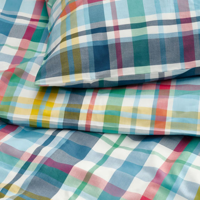 Colorful plaid fabric with a mix of blue, green, red, and yellow patterns.
