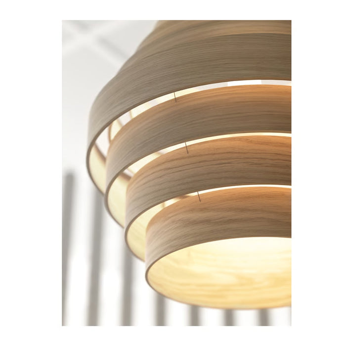 Close-up of a modern pendant light with wooden finish on a white background