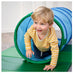 Child playing with a green and blue tunnel on a green mat.
