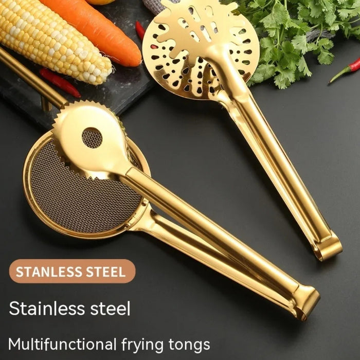 wo golden stainless steel frying tongs placed on a black surface—one with a mesh strainer and serrated edge, the other with circular perforations and raised grip bumps. The surrounding vegetables (corn, carrots, red chili, and cilantro) highlight their versatility.-1600003112384 13034149
