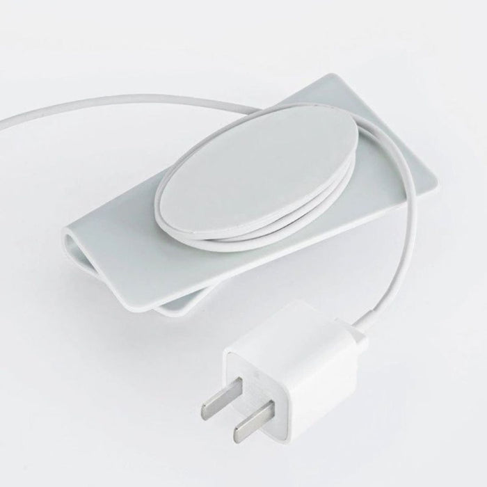 White electrical plug and socket set on a light gray background