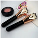 Digital Shoppy Two rose gold makeup brushes with compact blush container and floral card on flat surface