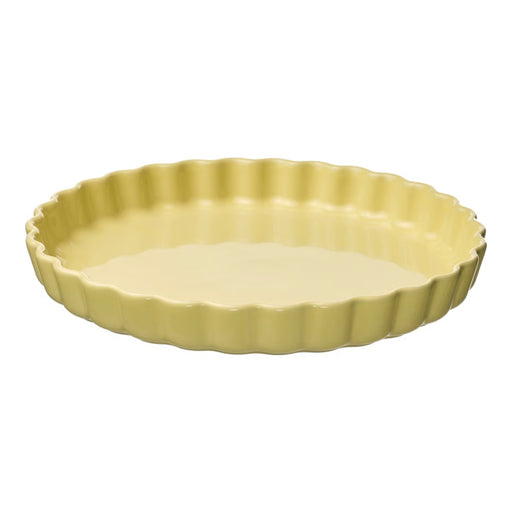 Yellow ceramic tart dish on a white background
