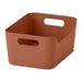 Brown storage basket with handles on a white background