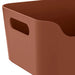 Brown storage bin with a handle on a white background