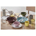 IKEA SPJUTLILJA whimsical stoneware dinnerware set styled on a wooden table