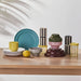 IKEA SPJUTLILJA side plates on a wooden table with colourful cups and vases bright table setting