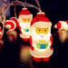 String of Santa Claus-shaped lights on a dark background