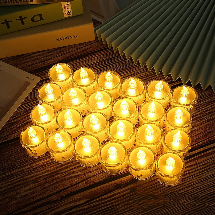 Set of small lit candles on a wooden surface with books in the background