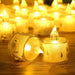 Two lit candles in decorative holders on a wooden surface with blurred candles in the background.