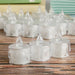 Clear plastic candles with small spires on a wooden surface