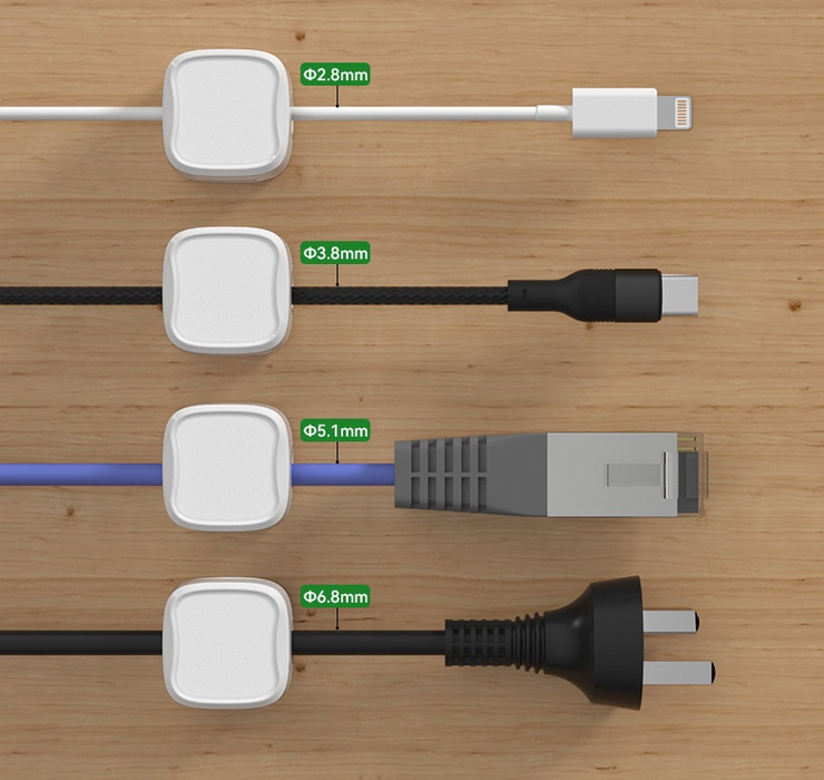 Six black magnetic cable clips arranged in packaging with under-desk mounting demonstration