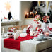 Festive table setting featuring the white and red VINTERFINT bowl used for serving snacks alongside holiday decor.