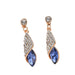 Pair of earrings with blue gemstones and rose gold accents on a white background