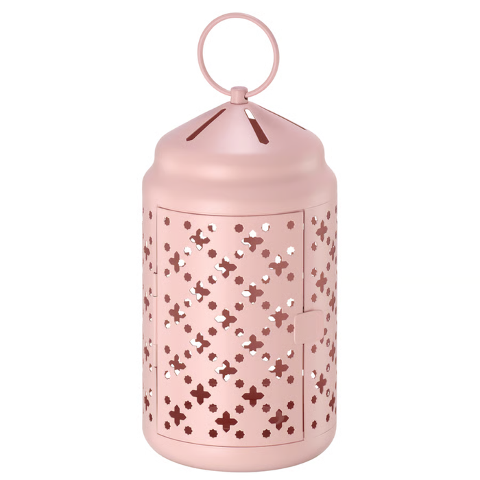 Pink metal lantern with clover and cross-shaped cutouts, domed top, and hanging ring, designed for tealights.