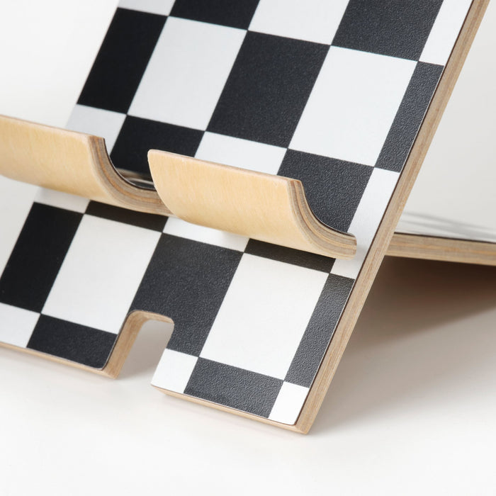 Close-up of IKEA PLUGGLAND mobile holder showing the graphic check pattern
