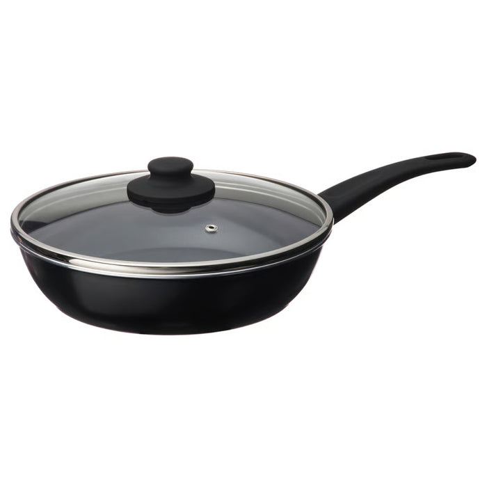 Black frying pan with glass lid on a white background