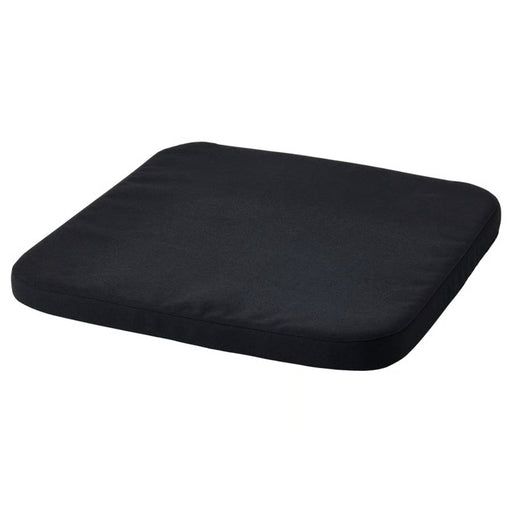 IKEA STAGGSTARR chair pad in solid black with rounded corners, shown flat against white background
