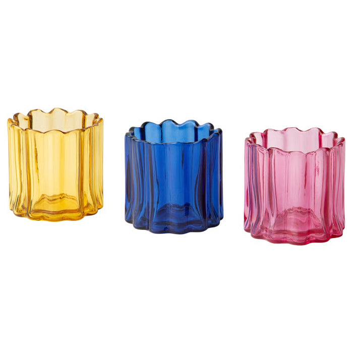 Three colorful glass candle holders on a white background