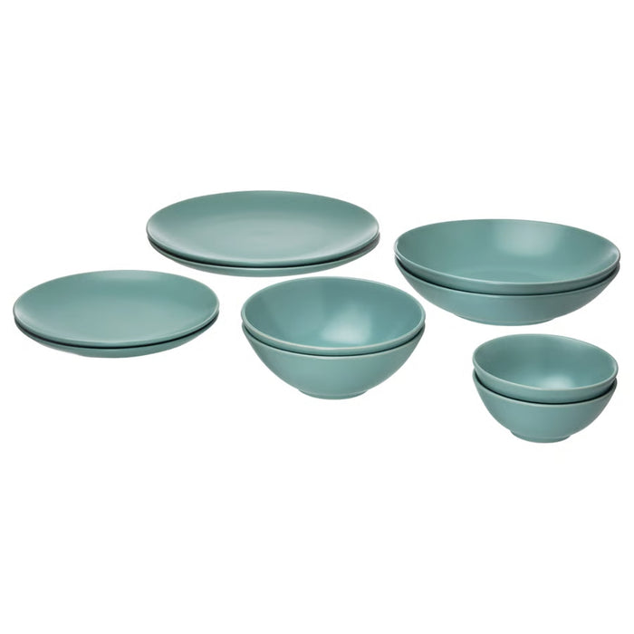 Set of teal ceramic plates and bowls on a white background