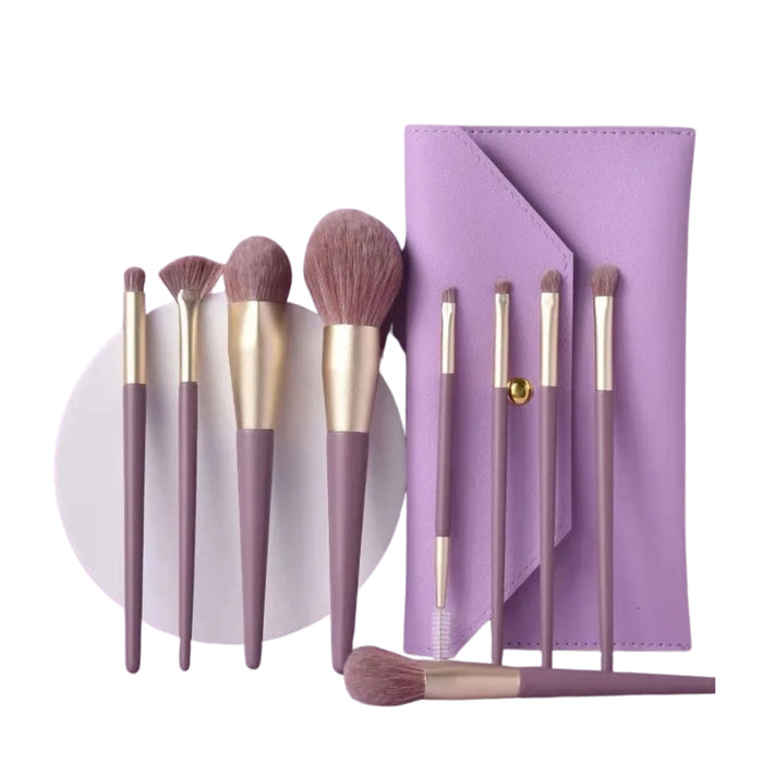 Set of makeup brushes with a purple case on a white background