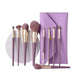 Set of makeup brushes with a purple case on a white background