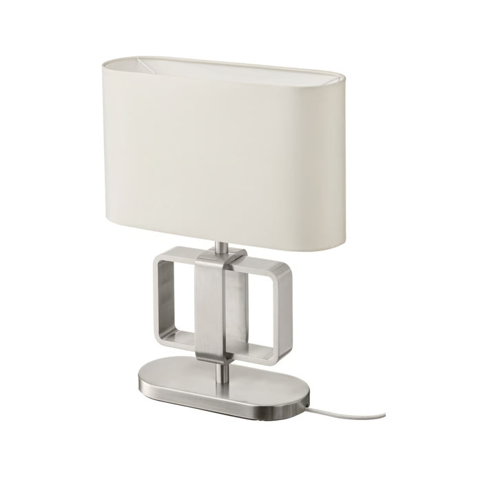 Table lamp with a white shade and metallic base on a white background