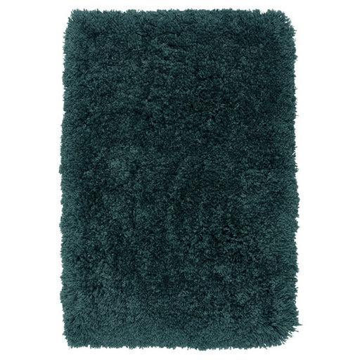Teal shaggy rug on a white background