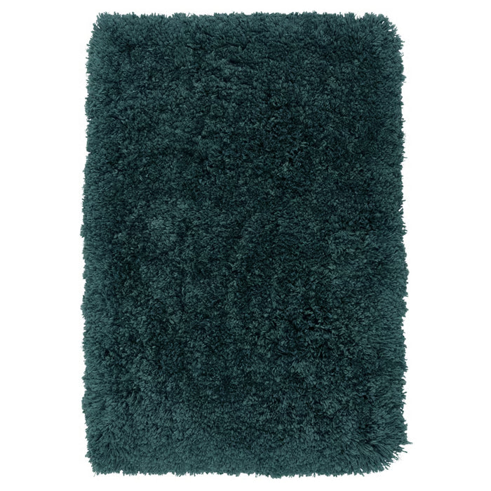 Teal shaggy rug on a white background