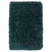 Teal shaggy rug on a white background