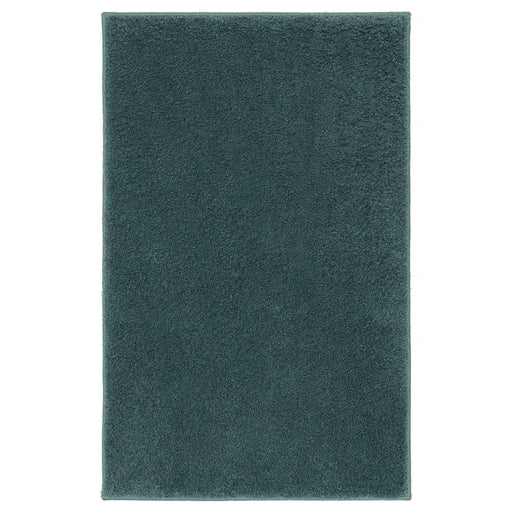 Solid teal IKEA BACKMÅRA Bathmat in Turquoise on a white background