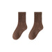 Pair of brown socks on a white background