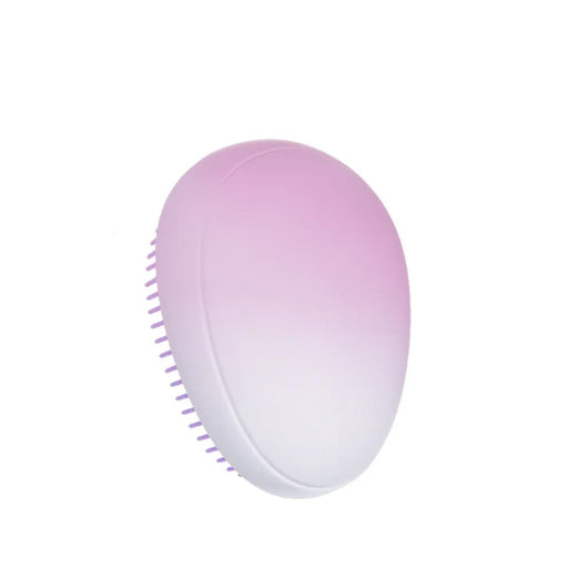 Portable small solid color massage comb placed on white background