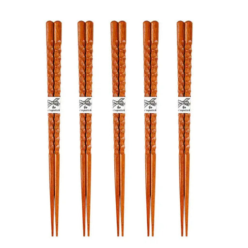 Set of five pairs of wooden chopsticks on a white background